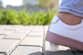 Woman stepping in chewing gum on sidewalk