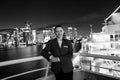 Woman steward on ship board at night in miami, usa. Sensual woman in suit jacket on city skyline. Water transport