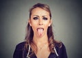 Closeup portrait of a woman sticking her tongue out