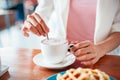 Woman stirring coffee