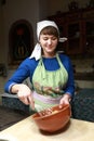 Woman stirring eggs with flour to make dough