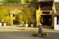 A woman with a stockade in thethe street in Hoi An