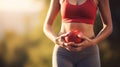 Woman, stomach and hand with heart in outdoor for exercise