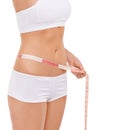 Woman, stomach and measure in studio for weight loss, tape and fitness for health. Female person, results on progress