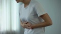 Woman with stomach pain touching tummy, suffering from gastritis, pancreatitis