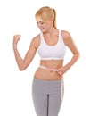 Woman, stomach and tape in studio for health, measuring and fitness for weight loss. Female person, excited on progress