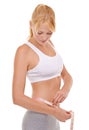 Woman, stomach and tape in studio for weight loss, measuring and fitness for health. Female person, results on progress