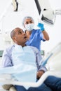 Woman stomatologist explaining treatment to patient in dental office