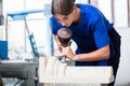 Woman Stonemason carving pillar out of stone in workshop Royalty Free Stock Photo