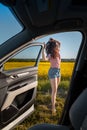 woman stop to enjoy sunset at road trip