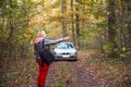 A woman stops a car on a forest road