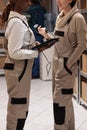 Woman storage workers checking scanned product in inventory software