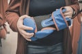 Woman in store chooses to buy blue gloves for a boxing. Hands close up shot