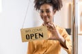 Woman store owner turning open sign broad through the door glass and ready to service. Small business woman owner turning the sign Royalty Free Stock Photo