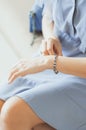 Woman straightens a bracelet on her hand, closeup