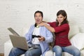 Woman strangling technology freak husband or boyfriend for being electronic devices and internet addiction concept Royalty Free Stock Photo