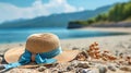 woman straw hat with blue bow and seashell on beach sand at mediterranean sea summer background copy space Royalty Free Stock Photo