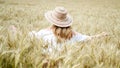 Woman in straw hat, cornfield, summer day