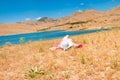 Woman in straw hat lying on dry grass Royalty Free Stock Photo