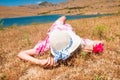 Woman in straw hat lying on dry grass Royalty Free Stock Photo