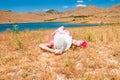 Woman in straw hat lying on dry grass Royalty Free Stock Photo