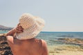 Woman with straw hat protects from sun Royalty Free Stock Photo