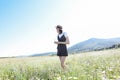 a woman in a straw hat walks in a field with daisies flowers in nature Royalty Free Stock Photo