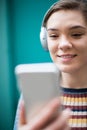 Woman Streaming Music From Mobile Phone To Wireless Headphones Royalty Free Stock Photo