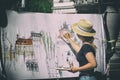 Woman street artist at work painting Royalty Free Stock Photo
