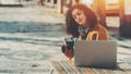 Woman in street bar with old camera and laptop Royalty Free Stock Photo