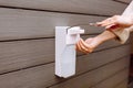 A woman on the street uses a hand sanitizer. Hand disinfection,protection and prevention against virus. Royalty Free Stock Photo