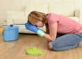 Woman stressed and tired cleaning the house washing the floor on her knees praying Royalty Free Stock Photo