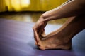 Woman stretch her feet to improve flexibility and mobility close up .at home natural light