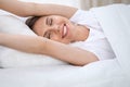 Woman stretching in bed after wake up, entering a day happy and relaxed after good night sleep. Sweet dreams, good