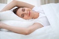 Woman stretching in bed after wake up, entering a day happy and relaxed after good night sleep. Sweet dreams, good Royalty Free Stock Photo
