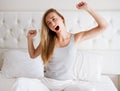 Woman stretching in bed after wake up, front view Royalty Free Stock Photo