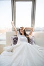 Woman stretching in bed after wake up in morning with sunlight Royalty Free Stock Photo