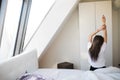 woman stretching in bed after wake up in morning with sunlight Royalty Free Stock Photo