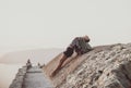 Woman stretching body on stones in Monolithos, Rhodes, Greece