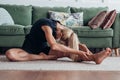 Woman stretching Head to Knee Forward Bend Woman in black sportwear Royalty Free Stock Photo