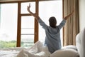 Woman stretching her hands, do morning exercises after awakening