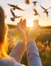 A woman stretching her hands out to the birds Royalty Free Stock Photo