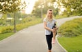 Woman is stretching before jogging in the park - Outdoors Fitness