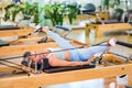 Woman stretching legs on pilates reformer