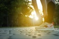 Woman stretching before morning run in park, closeup. Space for text Royalty Free Stock Photo