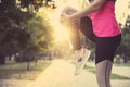 Woman stretching before morning run in park, closeup. Space for text Royalty Free Stock Photo