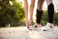 Woman stretching before morning run in park, closeup. Space for text Royalty Free Stock Photo