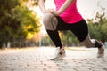 Woman stretching before morning run in park, closeup. Space for text Royalty Free Stock Photo