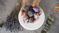 Woman stretching out macaroons in the hands.