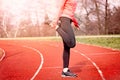 Woman stretching on a running track. Royalty Free Stock Photo